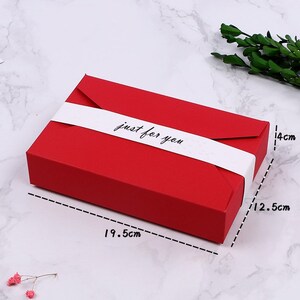May include: A rectangular red gift box, measuring 7.7 inches long, 4.9 inches wide, and 5.5 inches high, is wrapped with a white band that reads "just for you". The box is designed for gifting.