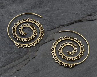May include: A pair of gold-toned spiral hoop earrings with intricate floral designs. The earrings are made of metal and have a circular shape.