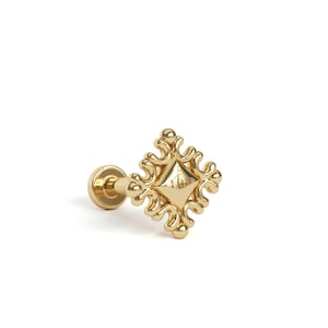 May include: A gold-coloured earring featuring an ornate square design. The earring has a post for insertion and a detailed, symmetrical pattern around a central diamond shape. The jewellery is set against a white background.