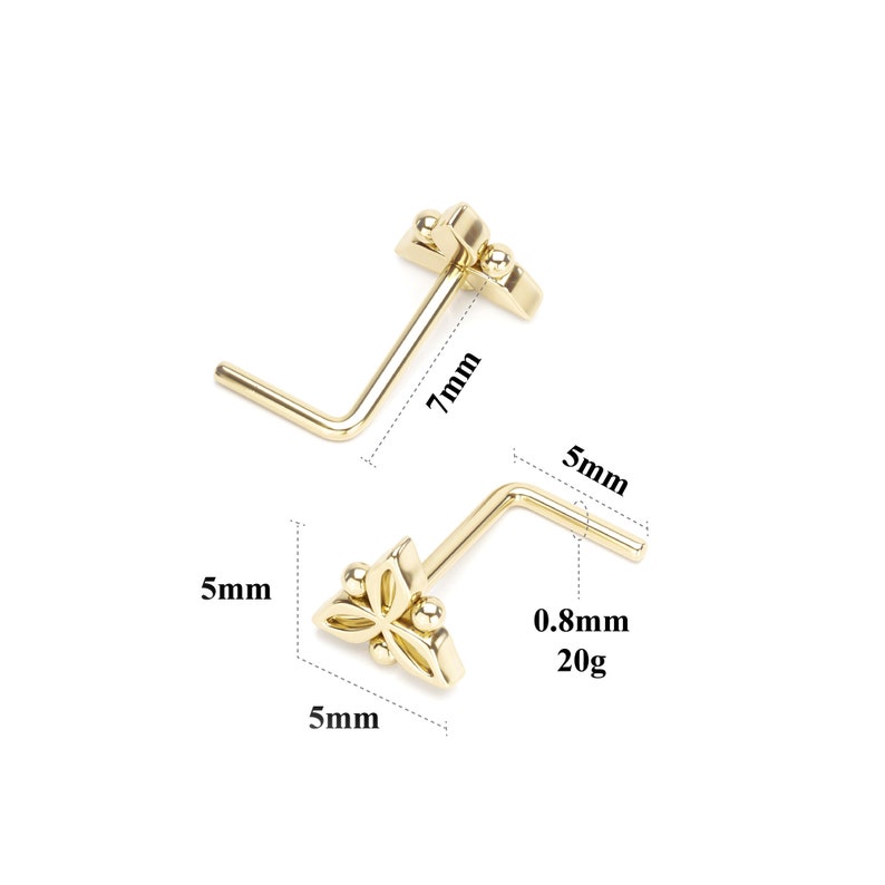 Pode incluir: Anel de nariz de ouro com design de flor. O anel tem 5 mm de largura e 7 mm de comprimento. Tem 0,8 mm de espessura e pesa 20 gauge.