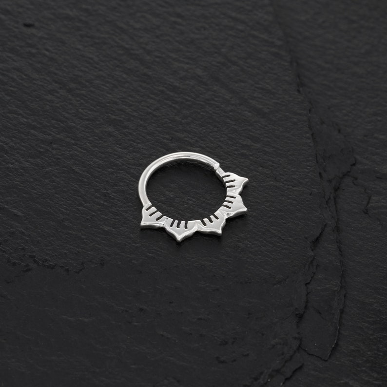Minimalist sterling silver septum ring with a unique lotus shape design.