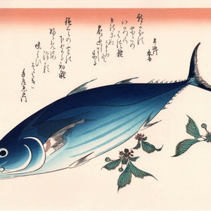 May include: A woodblock print of a blue and white fish with a detailed illustration of its scales. The fish is swimming to the right and has a sharp mouth. The print is on a white background with a light pink border. The print includes Japanese text.