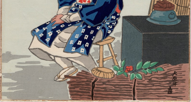 May include: A Japanese woodblock print depicting a person wearing a blue and white patterned robe sitting on a wooden stool. The person is holding a fan in their hand. The print is signed in Japanese characters.