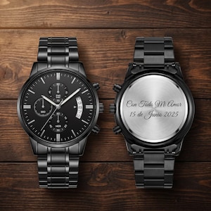 May include: Two black chronograph watches with matching metal bands are displayed. One watch shows the front with a black dial, sub-dials, and date display. The other watch shows the back with the inscription "Con Todo Mi Amor 15 de Junio 2025".
