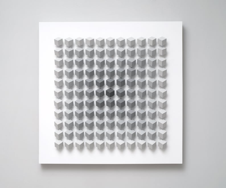 May include: A white square canvas with a grid of 64 gray cubes, each cube is a slightly different shade of gray, creating a gradient effect from light to dark.