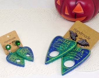 Creepy cute green and blue resin Ouija planchette earrings with glitter black bat studs