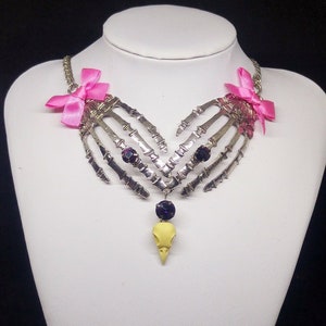 Skeleton bone hands necklace with resin raven skull and crystal rhinestones