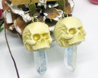 Dangle earrings with ivory-color skulls and natural quartz crystals