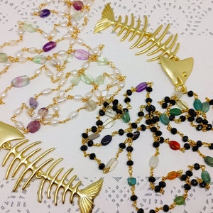 Maxi rosary-style chain necklace with crystal beads, freshwater pearls and natural stone beads, with chunky fishbone-shaped pendant.