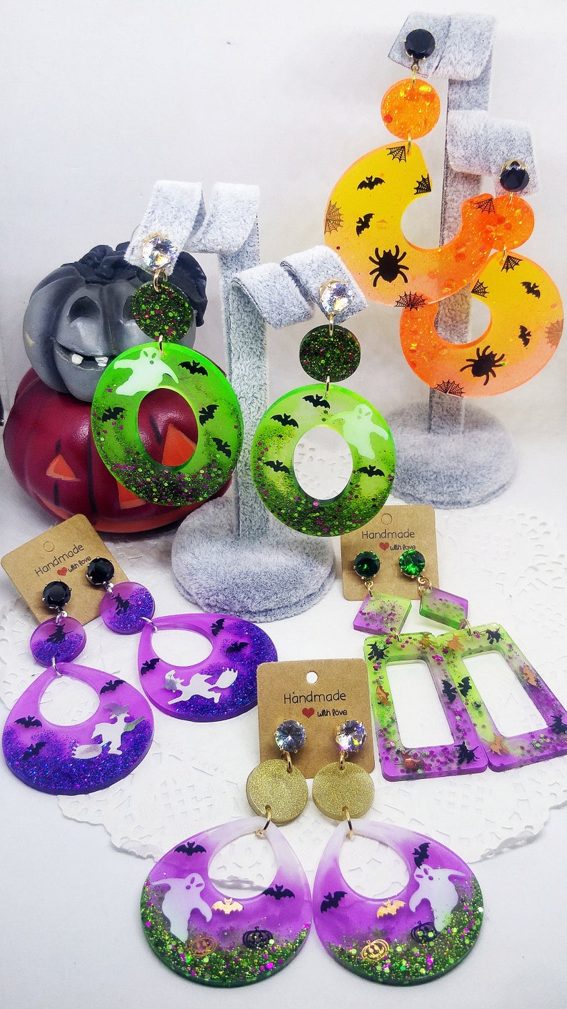 Halloween resin earrings with inclusion of holographic glitters and tiny bats, witches, ghosts, pumpkins and spiders 