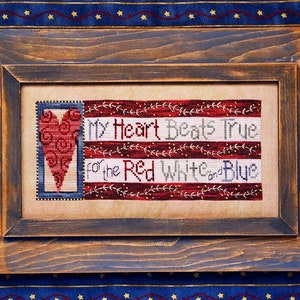 May include: A framed cross-stitch design featuring a red heart with a stylized design and the text "My Heart Beats True for the Red White and Blue".