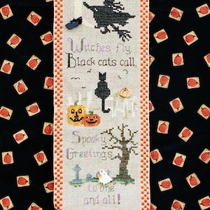 May include: A Halloween-themed banner with a black background patterned with orange pumpkins. The banner features a witch on a broom, a black cat, pumpkins, and the text "Witches fly, Black cats call, Spooky Greetings to one and all!"