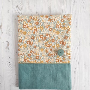 Health record cover in floral print fabric and linen fabric.