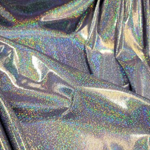 May include: Close-up of iridescent silver fabric with a subtle sparkle. The fabric has a smooth, shiny texture and is perfect for crafting or sewing projects.