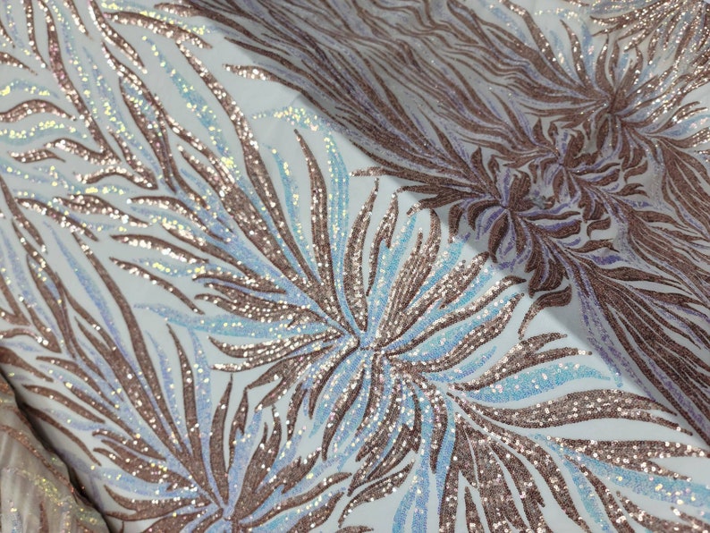 May include: White fabric with a rose gold and iridescent blue sequin pattern of stylized leaves.