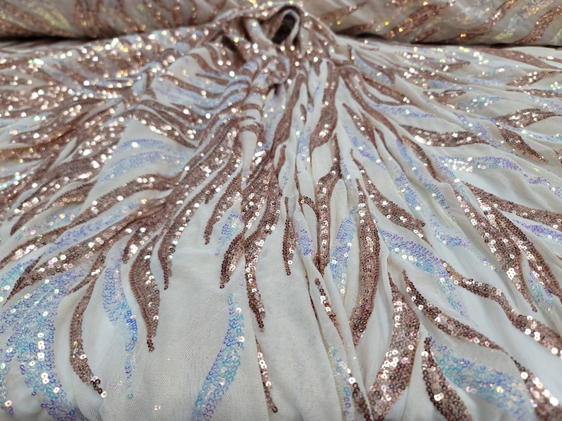 May include: White mesh fabric with iridescent sequins in a rose gold colour, arranged in a wavy pattern.