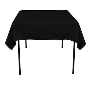 May include: A square black tablecloth draped over a black metal folding table. The tablecloth covers the entire table, with the edges hanging down. The table legs are thin and straight.