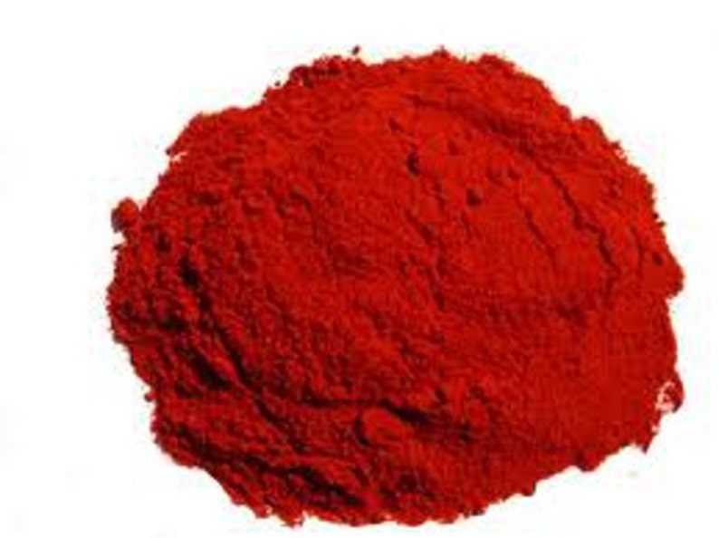 May include: A pile of bright red paprika powder, a common spice used in cooking.