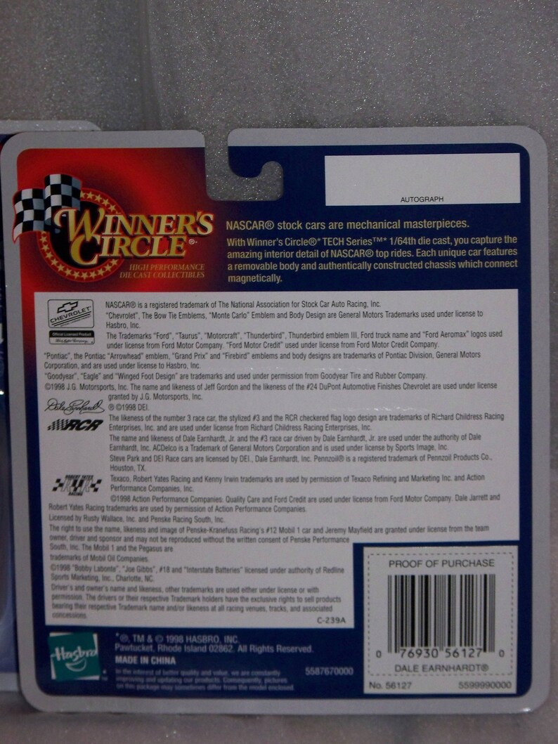 May include: Back of a Winner's Circle die-cast collectible NASCAR car package. The package features text about the car's features, trademarks, and a barcode. The package is blue, red, and white.