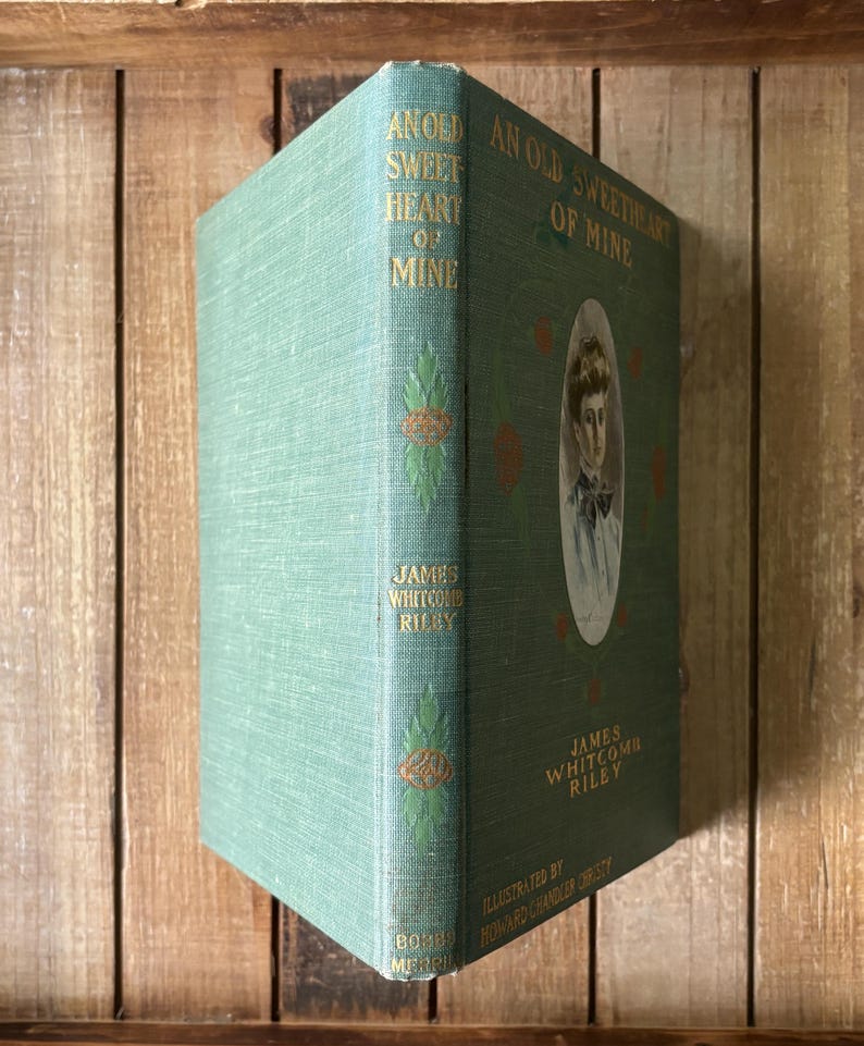 May include: A vintage hardcover book titled An Old Sweetheart of Mine by James Whitcomb Riley, featuring a sage green cloth cover with gold lettering, decorative green leaf motifs, and a central oval portrait of a person on the front cover.