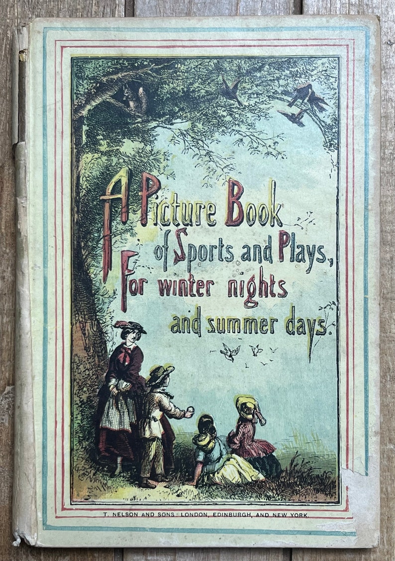 May include: A vintage book cover with a colorful illustration of children playing in a field. The title reads "A Picture Book of Sports and Plays, for winter nights and summer days."