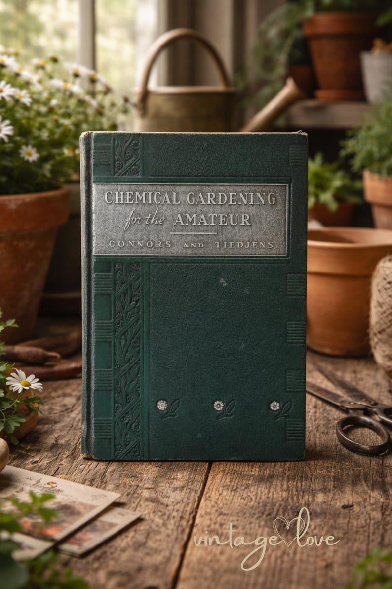 May include: A vintage book titled "Chemical Gardening for the Amateur" with a dark green cover and silver lettering. The book is surrounded by gardening tools and potted plants, suggesting a gardening theme. The book's cover has decorative floral elements.