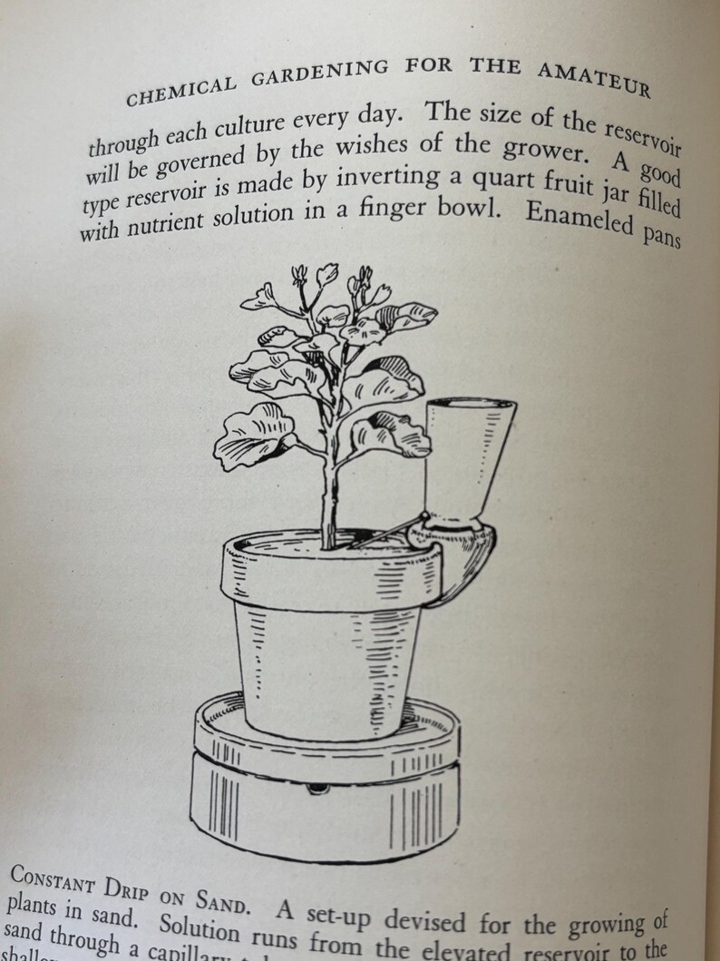 May include: An illustration from a vintage gardening book shows a potted plant with a unique watering system. The text reads "CHEMICAL GARDENING FOR THE AMATEUR". The plant sits atop a circular base, with a small cup attached to the side of the pot.