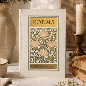 May include: A hardcover book titled Poems by Mary Baker Eddy with a cream-colored fabric cover. The front features a rectangular gold panel containing a repeating floral pattern of pink flowers and green leaves, with the title and author in black.