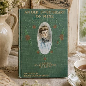 May include: A green hardcover book titled An Old Sweetheart of Mine by James Whitcomb Riley, illustrated by Howard Chandler Christy. The cover features a central oval portrait of a person with a bow tie, surrounded by embossed floral vine details.