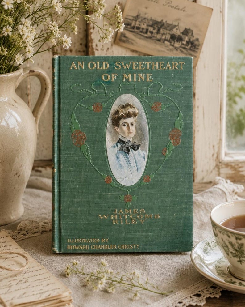 May include: A green hardcover book titled An Old Sweetheart of Mine by James Whitcomb Riley, illustrated by Howard Chandler Christy. The cover features a central oval portrait of a person with a bow tie, surrounded by embossed floral vine details.