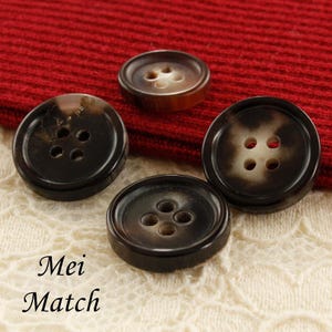 May include: Four brown and white four-hole buttons with a mottled pattern.