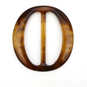 May include: An oval buckle with a tortoiseshell pattern, featuring a central bar. The buckle is made from a glossy, translucent material, displaying a mix of brown and amber tones. The design is simple and elegant, suitable for various accessories.
