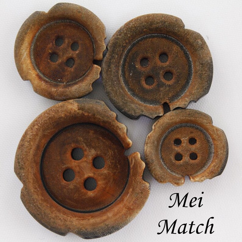 May include: Four brown wooden buttons, each with four holes. The buttons are arranged in a circle with the largest button in the centre.
