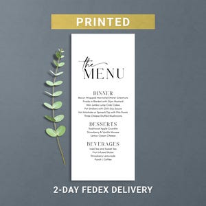May include: A white menu card with the text "the MENU" in elegant script. The menu lists dinner, dessert, and beverage options. A gold banner at the top reads "PRINTED". The bottom of the card reads "2-DAY FEDEX DELIVERY".