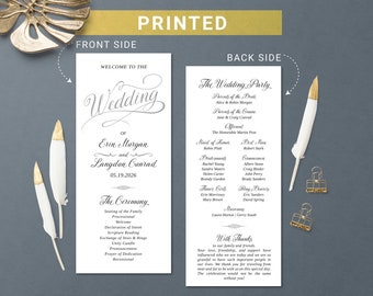 May include: A white wedding program with black text. The front side says "Welcome to the Wedding of Erin Morgan and Langdon Conrad 05.19.2026". The back side lists the wedding party, the officiant, the maid of honor, the best man, and the ceremony order.