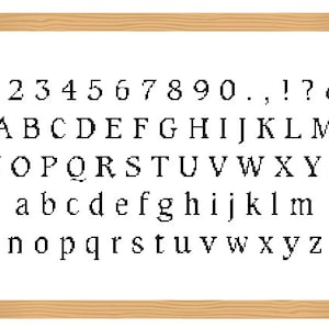 May include: A white framed chalkboard with black text showing the alphabet, numbers, and punctuation marks. The text reads: 1234567890.,!? & ABCDEFGHIJKLMNOPQRSTUVWXYZ abcdefghijklmnopqrstuvwxyz