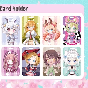 May include: Card holder with eight colorful anime-style character designs. Each card features a unique character with different hairstyles, outfits, and accessories. The background is a light pink with a floral pattern.