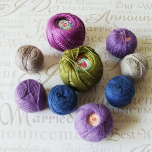 May include: A collection of colorful yarn balls in shades of purple, blue, green, and gray. The yarn balls are arranged on a patterned background with text related to weddings and announcements. Ideal for knitting and crochet projects.