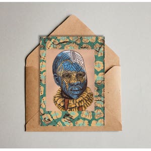 May include: A card with a blue and yellow patterned illustration of a person's face. The card is framed with a green and blue patterned border.