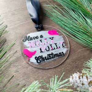 Have a Holly Dolly Christmas round acrylic holiday ornament, pink and black with ribbon