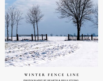 May include: A landscape photograph titled WINTER FENCE LINE by HEARTH & HILLS STUDIO, showing a snow-covered field with bare trees and a dark wooden fence line under a pale blue sky. The scene captures a quiet, cold winter day in the countryside.