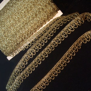 May include: Gold metallic trim with a scalloped edge. The trim is shown in two widths.
