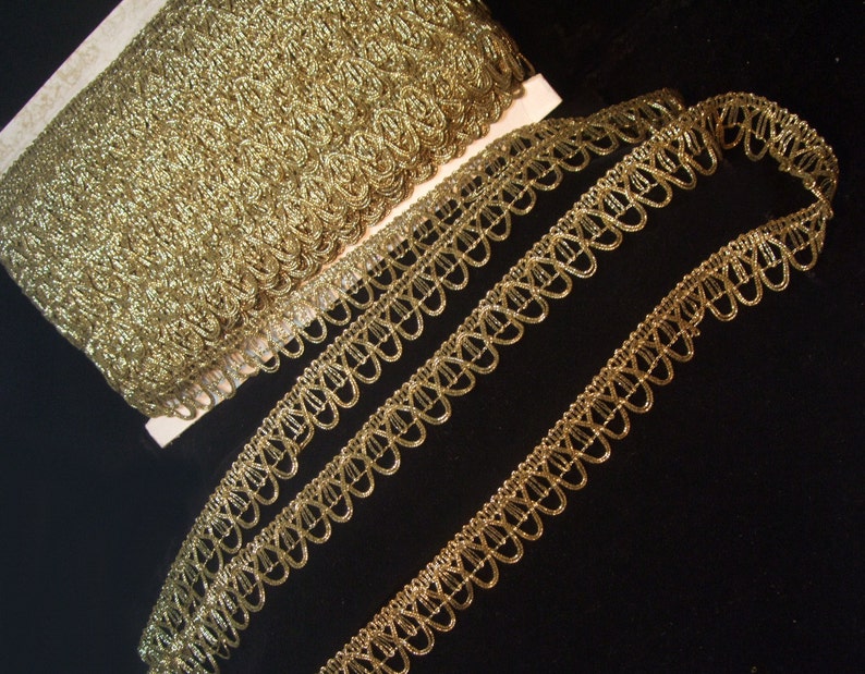 May include: Gold metallic trim with a scalloped edge. The trim is shown in two widths.