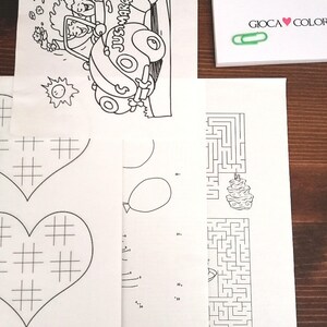 May include: A black and white coloring page with a car that says "Just Married" on the side, a heart with a grid pattern, a maze with a cake at the end, and a connect-the-dots activity with a balloon.