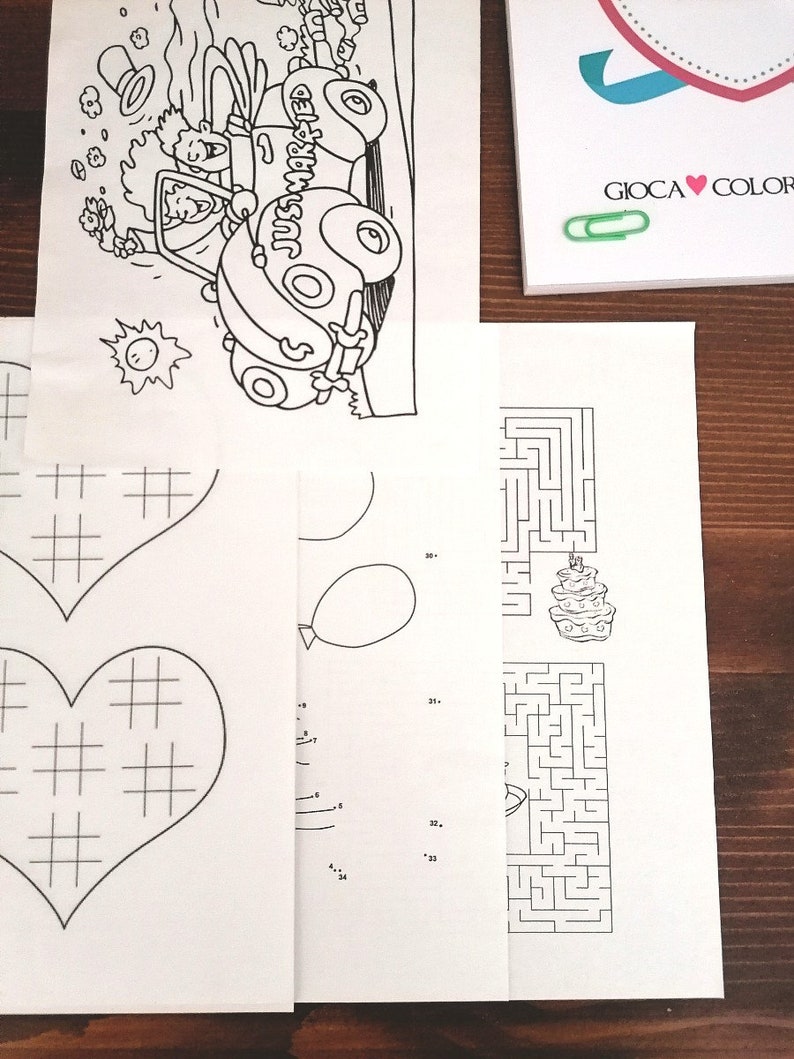 May include: A black and white coloring page with a car that says "Just Married" on the side, a heart with a grid pattern, a maze with a cake at the end, and a connect-the-dots activity with a balloon.