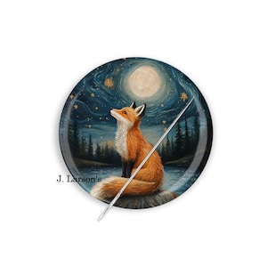 May include: A round button featuring a painting of a fox looking up at a full moon and stars in a night sky. The fox is orange and white and is sitting on a rock by a lake. The button is 2.25 inches in diameter.