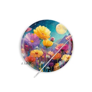 May include: A round decorative plate featuring a vibrant floral design with yellow, pink, and orange flowers under a night sky with a full moon. A silver pin is placed diagonally across the plate. The text "J. Larson's" is visible.