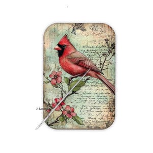 May include: A rectangular decorative item featuring a vibrant red cardinal bird perched on a flowering branch. The background has a vintage, aged appearance with script and floral elements. The artist's signature, "J. Larson", is visible.