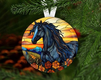 May include: A stained glass ornament featuring a black horse with a blue mane and tail, standing in a field of yellow flowers against a sunset background.