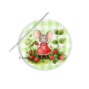 May include: A round, green and white gingham plate featuring a cartoon mouse in a red dress holding strawberries. A silver needle is placed diagonally across the plate. The text "J. Larson's" is visible.